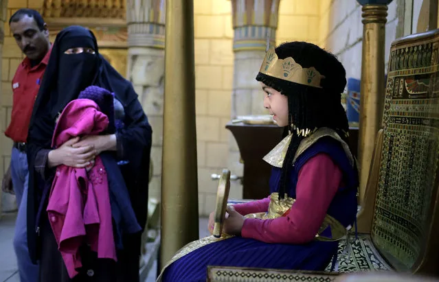 Mona Ahmed, 7, wearing a Pharaonic costume poses for a photograph at the studio of the Pharaonic Village, during Sham el-Nessim, or “smelling the breeze”, in Giza, Egypt, Monday, April 13, 2015. (Photo by Amr Nabil/AP Photo)