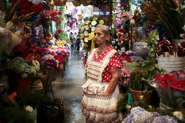 A woman sells flowers at the local market on the eve of Valentine's Day in Managua, Nicaragua February 13, 2016. (Photo by Oswaldo Rivas/Reuters)
