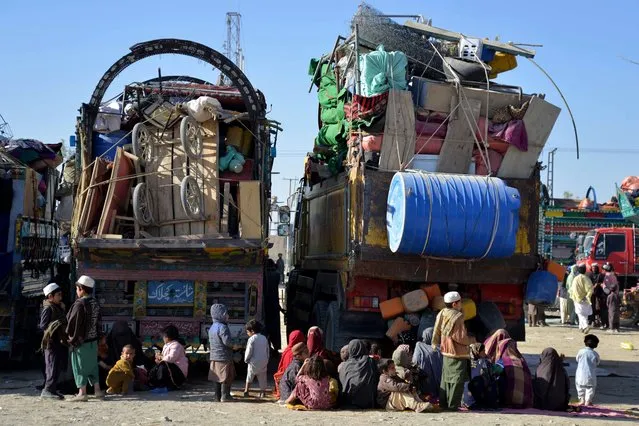 Afghan refugees sit beside their belongings at a registration centre upon their arrival from Pakistan, near the Afghanistan-Pakistan border in the Spin Boldak district of Kandahar province on November 20, 2023. Border officials say at least 210,000 Afghans, including many who have lived decades, if not their whole lives, outside their country, have passed through the Torkham border point since Pakistan ordered those without documents to leave. (Photo by Sanaullah Seiam/AFP Photo)
