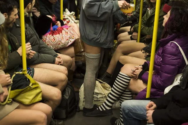 People taking part in the “No Pants Subway Ride” are seen on the U2 Subway line in Berlin on January 12, 2014. (Photo by Odd Andersen/AFP Photo)