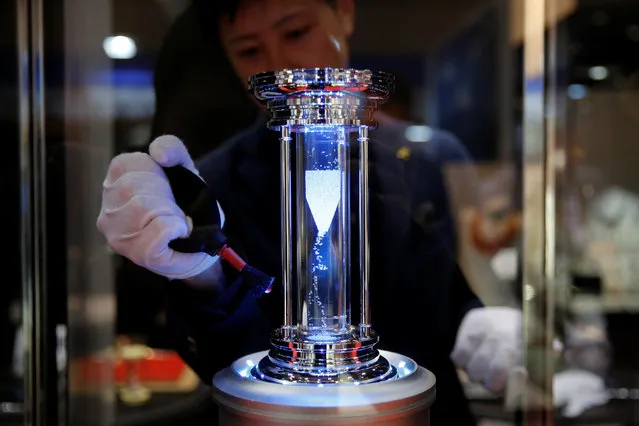 A Rainbow Diamond LLC employee cleans a diamond-filled hourglass that totals to 100 carats, at the International Jewellery Tokyo trade show in Tokyo, Japan January 24, 2017. (Photo by Toru Hanai/Reuters)