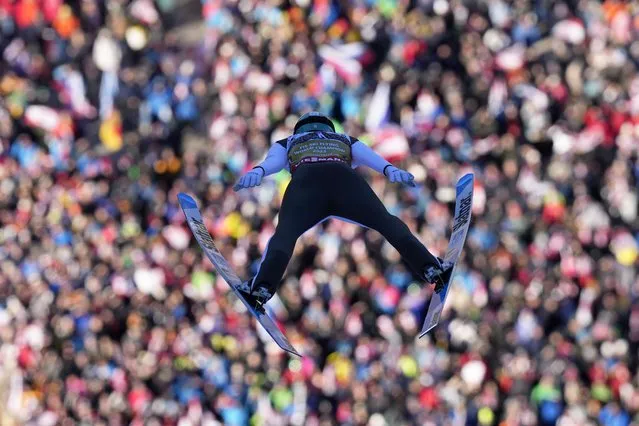 Lovro Kos, of Slovenia, soars through the air during his first round jump of the Men Team competition at the ski flying world championships, at the Kulmkogel mountain in Bad Mitterndorf, Austria, Sunday, January 28, 2024. (Photo by Matthias Schrader/AP Photo)