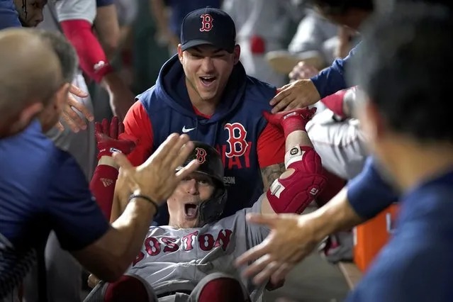 Boston Red Sox's Enrique Hernandez celebrates in the dugout after a home run against the Houston Astros during the third inning in Game 1 of baseball's American League Championship Series Friday, October 15, 2021, in Houston. (Photo by David J. Phillip/AP Photo)