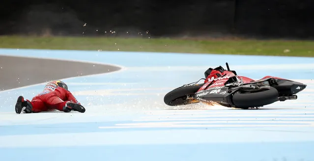 Andrea Dovizioso of Italy lies face down near his bike after a fall during a Moto GP free practice run at the circuit in Termas de Rio Hondo, Argentina, Saturday, March 30, 2019. Despite the fall Dovizioso will race in the third pole position on Sunday. (Photo by Nicolas Aguilera/AP Photo)