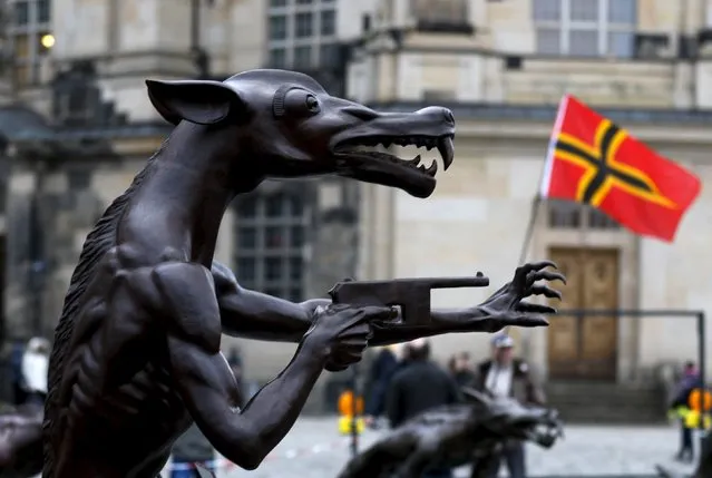 Sculptures by artist Rainer Opolka stand at the market square in Dresden, Germany, March 21, 2016. The 66 metal wolf sculptures are part of the exhibition “The wolves are back” which is to focus on the hazards of xenophobia, hate and right-wing extremism and will remain at Neumarkt in Dresden until March 23. (Photo by Ina Fassbender/Reuters)