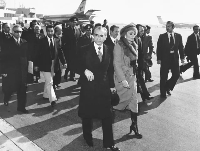 In this January 16, 1979 file photo, Shah Mohammad Reza Pahlavi and Empress Farah walk on the tarmac at Mehrabad Airport in Tehran, Iran, to board a plane to leave the country. Forty years ago, Iran's ruling shah left his nation for the last time and an Islamic Revolution overthrew the vestiges of his caretaker government. The effects of the 1979 revolution, including the takeover of the U.S. Embassy in Tehran and ensuing hostage crisis, reverberate through decades of tense relations between Iran and America. (Photo by AP Photo/File)
