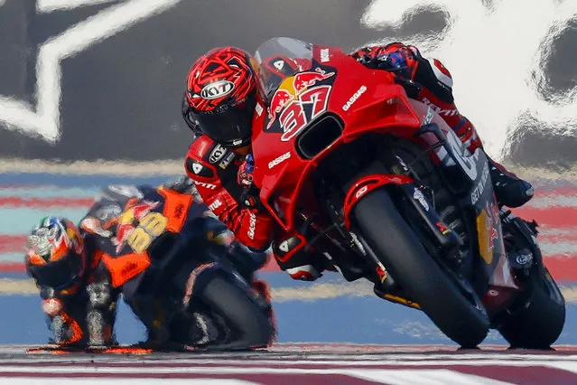 Red Bull GASGAS Tech3 Spanish rider Augusto Fernandez (foreground) and Red Bull KTM Factory Racing South African rider Brad Binder (background) steer their bikes during the first free practice session of the Qatar MotoGP Grand Prix at the Lusail International Circuit in Lusail, north of Doha on March 8, 2024. (Photo by Karim Jaafar/AFP Photo)