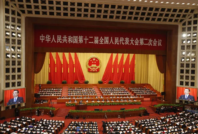 Delegates and officials gather for the Second Session of the 12th National Peoples Congress (NPC) at the Great Hall of the People in Beijing, China, 05 March 2014. (Photo by Rolex Dela Pena/EPA)