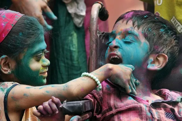 Specially abled children participate in an early celebration of Holi, the Hindu festival of colors, at their school in Mumbai, India, Friday, March 22, 2024. (Photo by Rajanish Kakade/AP Photo)