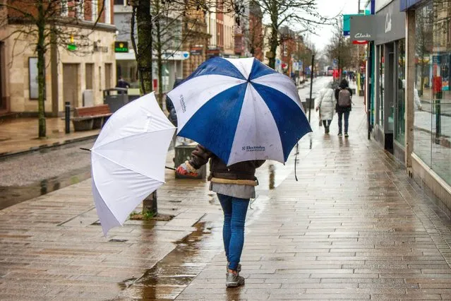 Rainy start to the day for shoppers in the city centre in Lancashire. UK on March 14, 2024. (Photo by Media World Images/Alamy Live News)