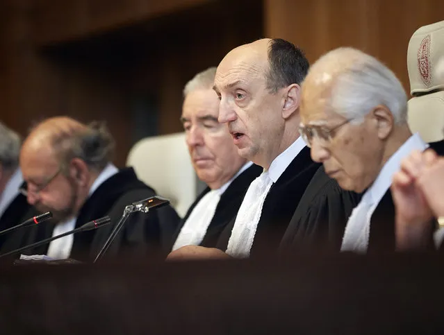 Judge Peter Tomka, center, president of the International Court of Justice, delivers its verdict in The Hague, Netherlands, Monday March 31, 2014. “The court concludes that the special permits granted by Japan for the killing, taking, and treating of whales ... are not for purposes of scientific research”, Tomka said. The International Court of Justice is ruling Monday on Australia's challenge against Japan for whaling in Antarctic waters. (Photo by Phil Nijhuis/AP Photo)
