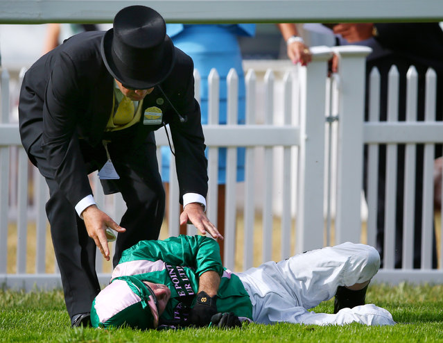 Horse Racing - Royal Ascot - Ascot Racecourse - 17/6/15
Jimmy Fortune lies injured after falling off Spark Plug during the 17.00 Royal Hunt Cup
Reuters / Eddie Keogh
Livepic
