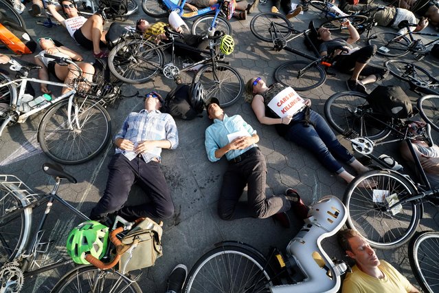 People take part in a “Die In” protest to bring attention to cycling injuries and deaths while riding on roads, in the Manhattan borough of New York, U.S., July 9, 2019. (Photo by Carlo Allegri/Reuters)