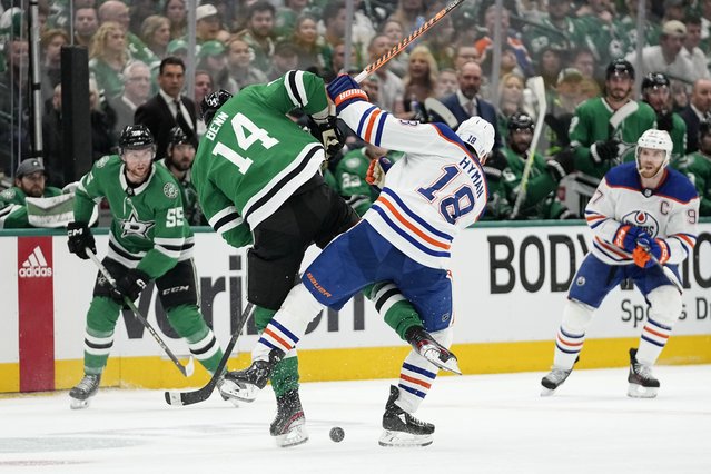 Dallas Stars' Jamie Benn (14) and Edmonton Oilers' Zach Hyman (18) collide while competing for the puck during the second period of Game 1 of the Western Conference finals in the NHL hockey Stanley Cup playoffs Thursday, May 23, 2024, in Dallas. (Photo by Tony Gutierrez/AP Photo)