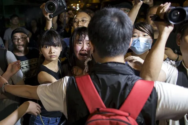Localist protesters react after scuffles broke out against pro-China demonstrators during an anti-China protest at Mongkok shopping district in Hong Kong, China June 28, 2015. (Photo by Tyrone Siu/Reuters)
