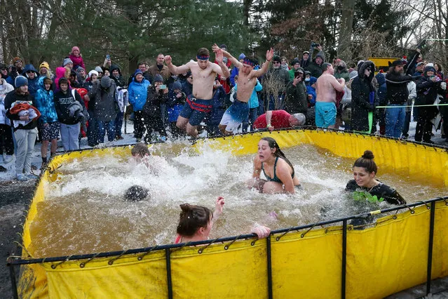 People participate in the annual Lewisburg Polar Bear Plunge in Pennsylvania on February 5, 2022. Proceeds from the event benefit Lewisburg Neighborhoods, which works to revitalize downtown Lewisburg. (Photo by Paul Weaver/SOPA Images/Rex Features/Shutterstock)
