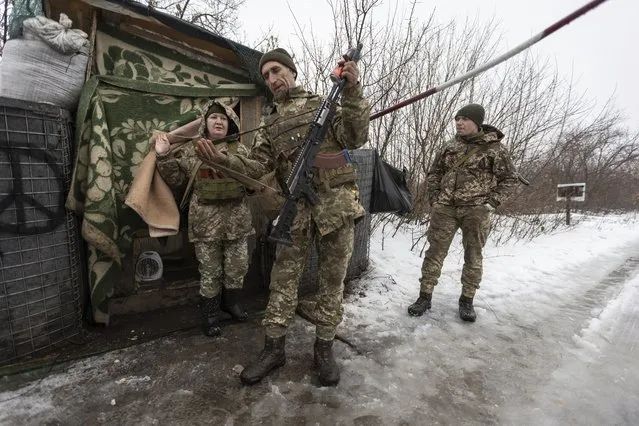 Ukrainian servicemen guard a checkpoint at the line of separation in the Luhansk region, in Luhansk, Ukraine, Thursday, February 3, 2022. (Photo by Andriy Dubchak/AP Photo)