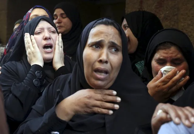 Relatives of 21-year-old Mohamed Adel, one of the army officers who died in yesterday's Sinai attacks, cry during the funeral in Al-Kaliobeya, near Cairo, Egypt, July 2, 2015. (Photo by Mohamed Abd El Ghany/Reuters)