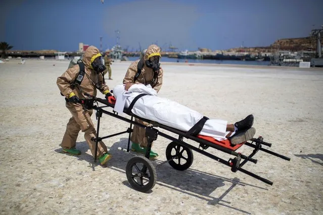 Members of the Moroccan Royal Armed Forces Rescue & Relief Unit take part in a biochemical simulation organized by the U.S Defense Threat Reduction Agency (DTRA) as part of African Lion military exercise, in the port of Agadir, southern Morocco, Tuesday, June 15, 2021. With more than 7,000 participants from nine nations and NATO, African Lion is U.S. Africa Command's largest exercise. (Photo by Mosa'ab Elshamy/AP Photo)