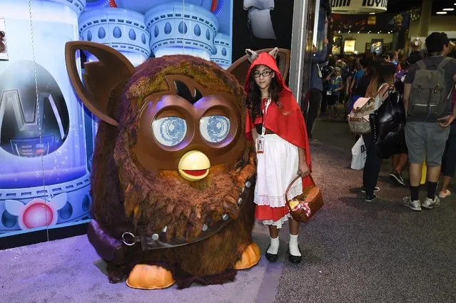 Natalia Knapp poses with a Furbaca on display on Preview Night at Comic-Con International held at the San Diego Convention Center Wednesday July 8, 2015 in San Diego. (Photo by Denis Poroy/Invision/AP Photo)