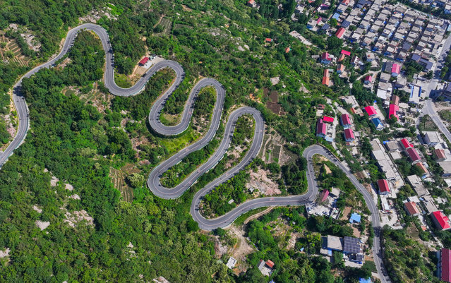 Photo taken on June 1, 2024 shows a winding rural road in Yuwan village, Yuntai Street, Lianyungang city, East China's Jiangsu province. (Photo credit should read CFOTO/Future Publishing via Getty Images)