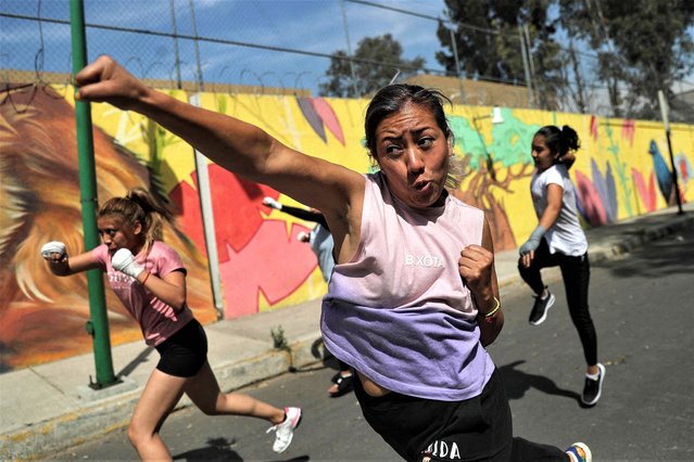 Women participate in a self-defense class that combines martial arts with simple street fighting techniques, in a street of the Iztapalapa neighborhood on the outskirts of Mexico City, Mexico on March 7, 2023. (Photo by Raquel Cunha/Reuters)
