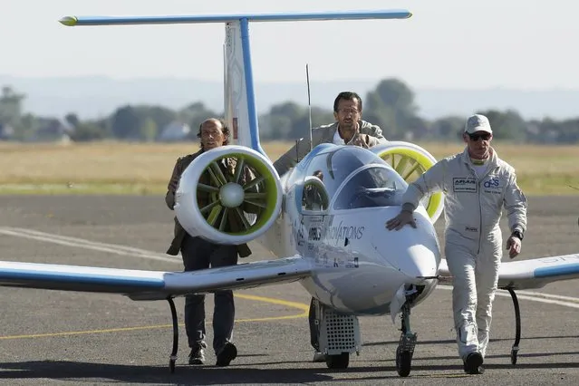 Pilot and designer Didier Esteyne (R) prepares to take off in the Airbus Group E-Fan electric aircraft, during an attempt to fly across the channel from Lydd Airport in southeast England, Britain July 10, 2015. (Photo by Luke MacGregor/Reuters)