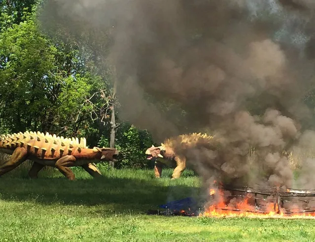 This photo provided by the Leonia, N.J., Police Department shows a fire that destroyed a 90-foot animatronic dinosaur at Overpeck County Park in Leonia, N.J., Thursday, May 12, 2016. The fire has destroyed the animatronic dinosaur that was set to be part of an exhibit at the theme park. (Photo by Leonia Police Department via AP Photo)