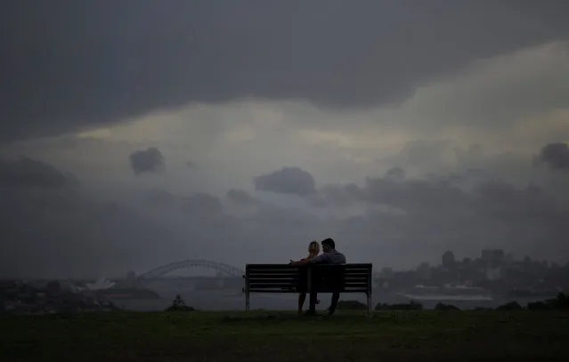 A couple observe a rain storm over Sydney, Australia, as a supercell hits Australia's most populous city, March 13, 2017. (Photo by Jason Reed/Reuters)