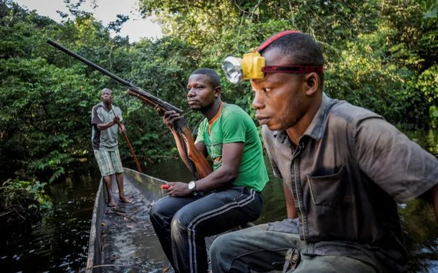 Mohamed Esimbo Matongu, Sadate and Papy return to their campsite empty-handed after a night hunting in the forest near the city of Mbandaka, Democratic Republic of the Congo, April 3, 2018. (Photo by Thomas Nicolon/Reuters)