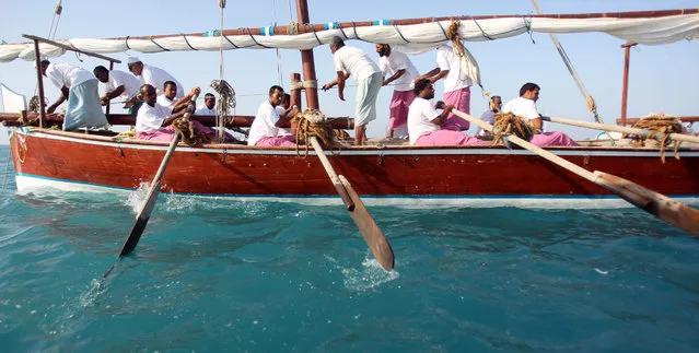 Sailers paddle a dhow in the Gulf water during the final training a day before the Al-Gaffal 60ft traditional dhow sailing race between the island of Sir Bu Nair, near the Iranian coast, and the Gulf emirate of Dubai on May 27, 2011. (Photo by Karim Sahib/AFP Photo)