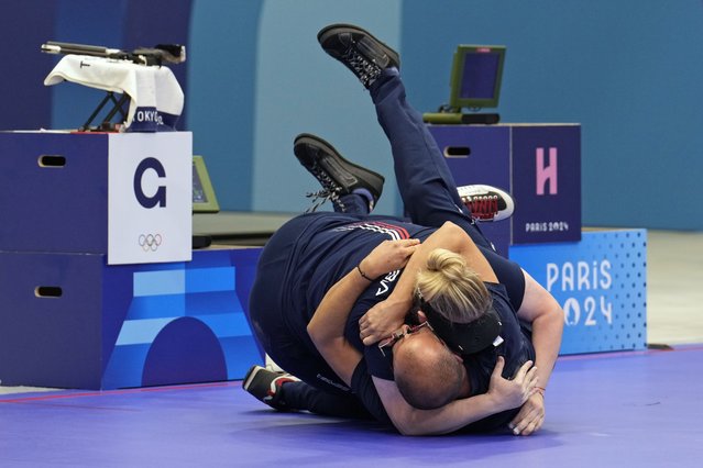 Serbia's Zorana Arunovic, left, and Turkey's Yususf Dikec hug and roll on the ground as they celebrate after winning the gold medal in the 10m air pistol mixed team event at the 2024 Summer Olympics, Tuesday, July 30, 2024, in Chateauroux, France. (Photo by Manish Swarup/AP Photo)