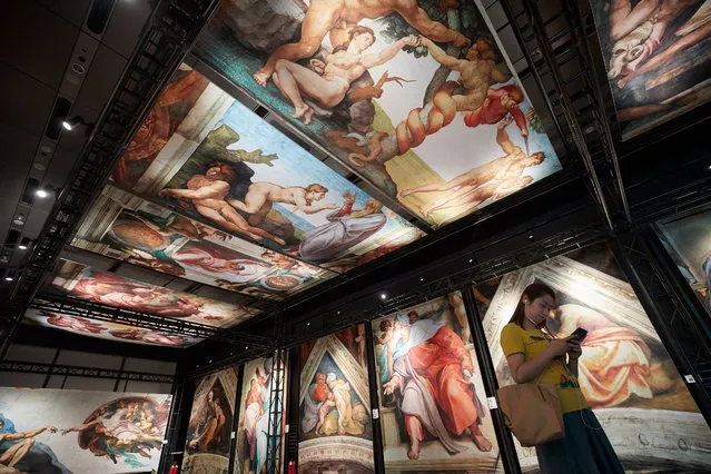 A person visits the Michelangelo's Sistine Chapel Exhibition Global Tour at the Shanghai World Financial Center in Shanghai, China, 08 June 2017. The show features 1:1 replicas of Michelangelo's frescoes of Genesis and The Last Judgment that adorn the ceiling of the Vatican's Sistine Chapel. The show will run from 07 June to 07 October. (Photo by EPA/Sherwin)