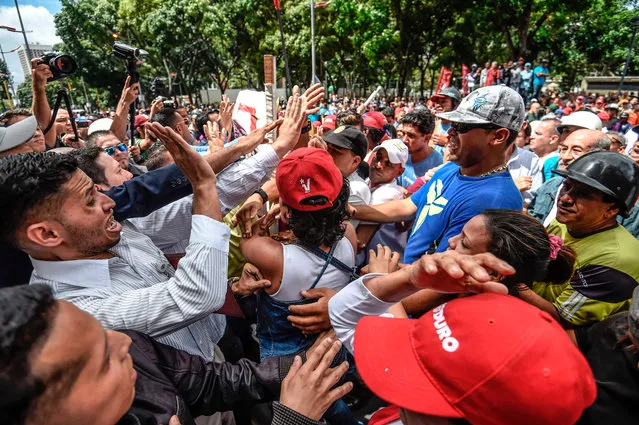General Prosecutor' s office employees (L) demonstrating in support of Attorney General Luisa Ortega face supporters of Venezuelan President Nicolas Maduro (R) in Caracas on June 19 , 2017. Venezuela' s Supreme Court on Friday rejected a bid to put on trial several senior judges accused of favoring embattled President Nicolas Maduro as he clings to power in the face of deadly unrest. (Photo by Juan Barreto/AFP Photo)