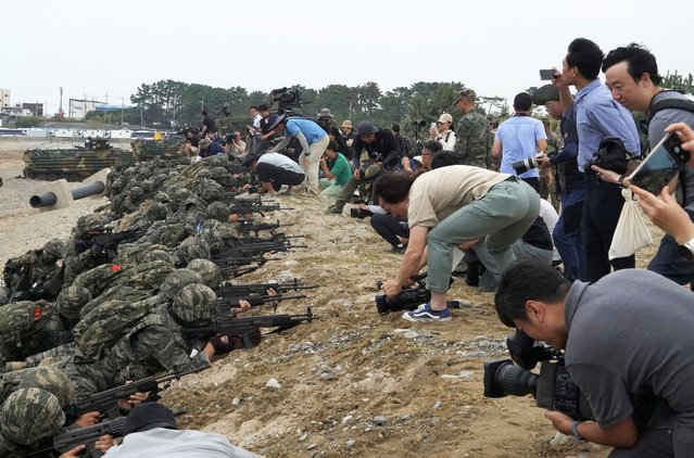 Medias film as South Korean Marines take positions after landing on the beach during the combined military amphibious landing exercise between South Korea and the U.S., called Ssangyong exercise, in Pohang, South Korea, Monday, September 2, 2024. (Photo by Ahn Young-joon/AP Photo)