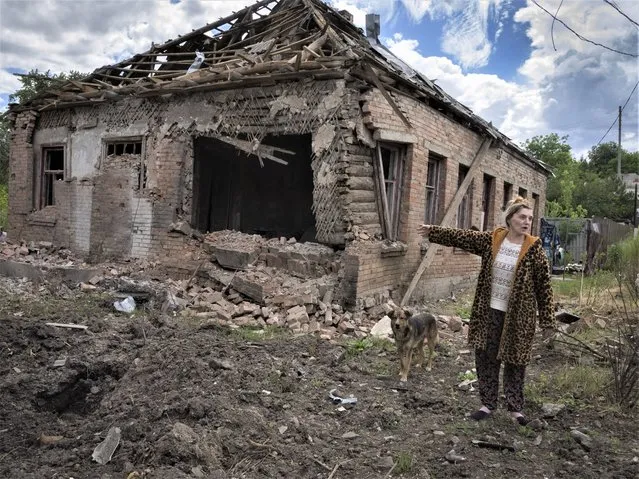 Local resident Tetyana points at her house heavily damaged by the Russian shelling in Bakhmut, Donetsk region, Ukraine, Friday, June 24, 2022. (Photo by Efrem Lukatsky/AP Photo)