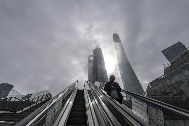 A pedestrian rides an escalator in Pudong's Lujiazui Financial District in Shanghai, China, on Monday, October 21, 2024. China's domestic yuan traders appear to be more confident than their offshore counterparts that the currency's turbulence will be contained around the US presidential election period. (Photo by Qilai Shen/Bloomberg)