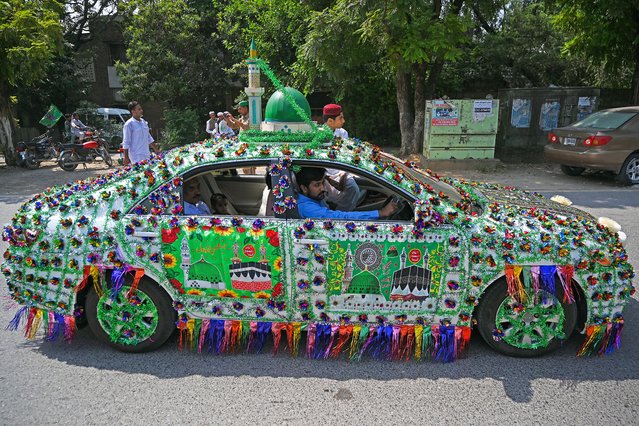 Sunni Muslims ride on a decorated vehicle as they take part in a rally to celebrate Eid-e-Milad-un-Nabi, the birthday of Prophet Mohammed, in Islamabad on September 17, 2024. (Photo by Aamir Qureshi/AFP Photo)