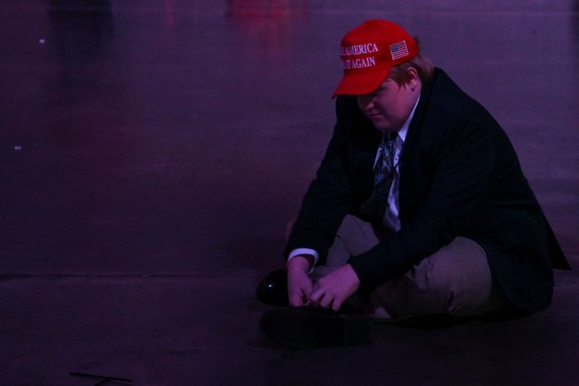 An attendee sits on the floor at Donald Trump's election night watch party in Palm Beach County Convention Center, in West Palm Beach, Florida on November 6, 2024. (Photo by Callaghan O'hare/Reuters)