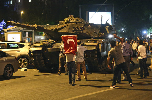 A tank moves into position as Turkish people attempt to stop them, in Ankara, Turkey, early Saturday, July 16, 2016. (Photo by AP Photo)