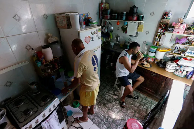 Manoel Pereira Costa (L), known as “Master Manel”, prepares coffee next to his son Miquelangelo de Souza Sobrinho Costa at their home in Rio de Janeiro, Brazil, July 26, 2016. (Photo by Bruno Kelly/Reuters)