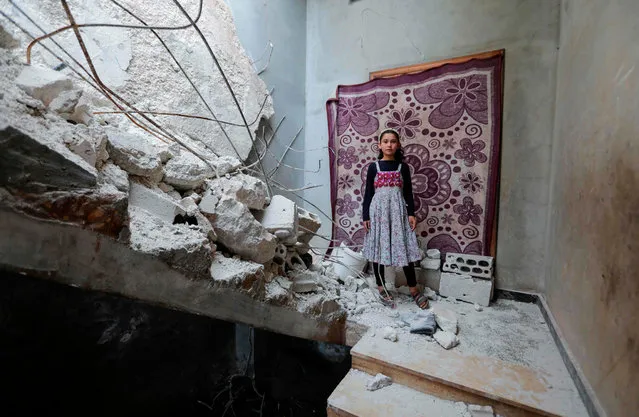 A Syrian girl whose family decided to return home for fear of the COVID-19 pandemic in packed camps for the internally displaced, poses for a picture amid the rubble in her damaged house in al-Nayrab, a village ravaged by pro-government forces bombardment near the M4 strategic highway, in Syria's northwestern Idlib province, on May 3, 2020. (Photo by Bakr Alkasem/AFP Photo)