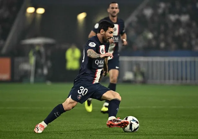 Paris Saint-Germain's Argentine forward Lionel Messi runs with the ball during the French L1 football match between Olympique Lyonnais (OL) and Paris Saint-Germain (PSG) at The Groupama Stadium in Decines-Charpieu, central-eastern France, on September 18, 2022. (Photo by Jeff Pachoud/AFP Photo)