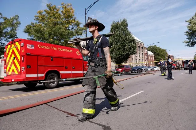 A first responder works the scene after a building explosion caused injuries and scattered bricks and debris in Chicago, Illinois, U.S. September 20, 2022. (Photo by Kamil Krzaczynski/Reuters)