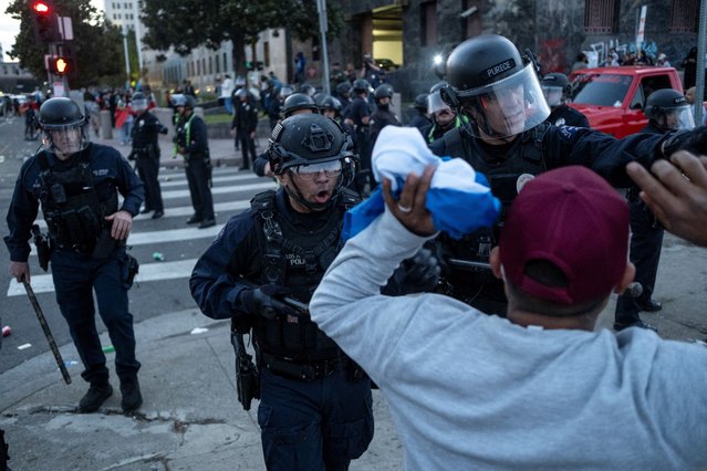 Police officers confront protestors during a rally against arrests and deportations of migrants by U.S. government agencies in Los Angeles, California, U.S. February 3, 2025. (Photo by Joel Angel Juarez/Reuters)
