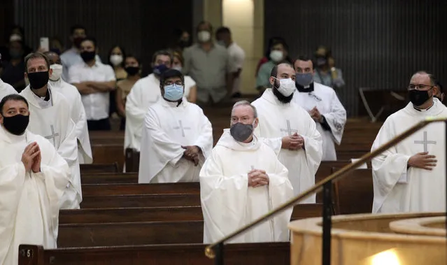 In this photo taken Saturday, June 20, 2020, priests from the Rio Grande Valley wear face masks against the spread of the coronavirus as they attend a Priestly Ordination Ceremony at the Basilica of Our Lady of San Juan Del Valle in San Juan, Texas. (Photo by Delcia Lopez/The Monitor via AP Photo)