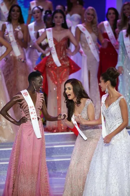 Miss India Manushi Chhilar (C) reacts as she wins the 67 th Miss World contest final next to France Aurore Andrée Raphaëlle Kichenin (R) and Miss Kenya Magline Jeruto (L) in Sanya, on the tropical Chinese island of Hainan on November 18, 2017. (Photo by China Photo/AP Photo)