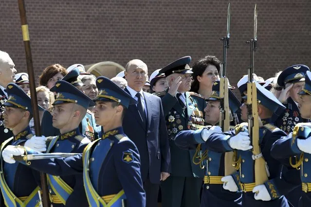 Russian President Vladimir Putin, center, takes part in a wreath laying ceremony at the Tomb of Unknown Soldier in Moscow, Russia, Monday, June 22, 2020, marking the 79th anniversary of the Nazi invasion of the Soviet Union. (Photo by Alexei Nikolsky, Sputnik, Kremlin Pool Photo via AP Photo)