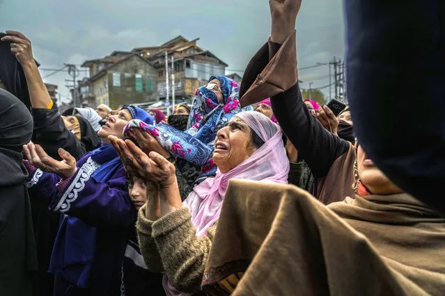 Kashmiri Muslim women devotees weep while praying as a priest displays a relic of Sufi saint Sheikh Syed Abdul Qadir Jeelani outside his shrine in Srinagar, Indian controlled Kashmir, Monday, November 7, 2022. Hundreds of devotees have gathered at the shrine for the 11-day festival that marks the death anniversary of the Sufi saint. (Photo by Mukhtar Khan/AP Photo)