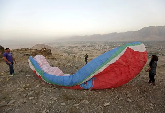 Afghan paragliders prepare to launch from a mountain in Kabul, Afghanistan September 17, 2015. (Photo by Mohammad Ismail/Reuters)